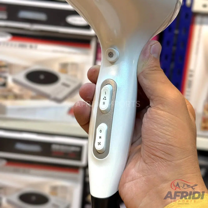White hairdryer with two sliding switches for heat and fan settings.