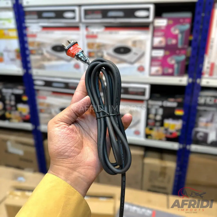 A coiled black power cord with an orange two-prong plug.