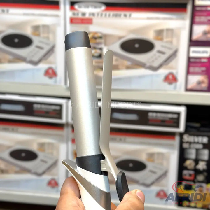 Silver and black hair curling iron with a spring-loaded clamp.