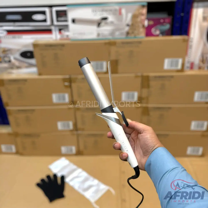 White and silver hair curling iron with a black power cord.