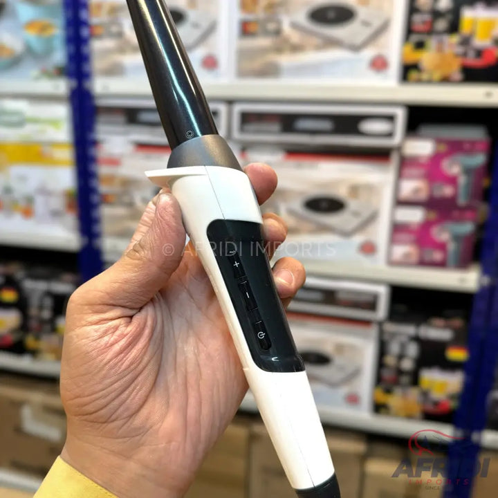 White and black conical curling iron with temperature controls.