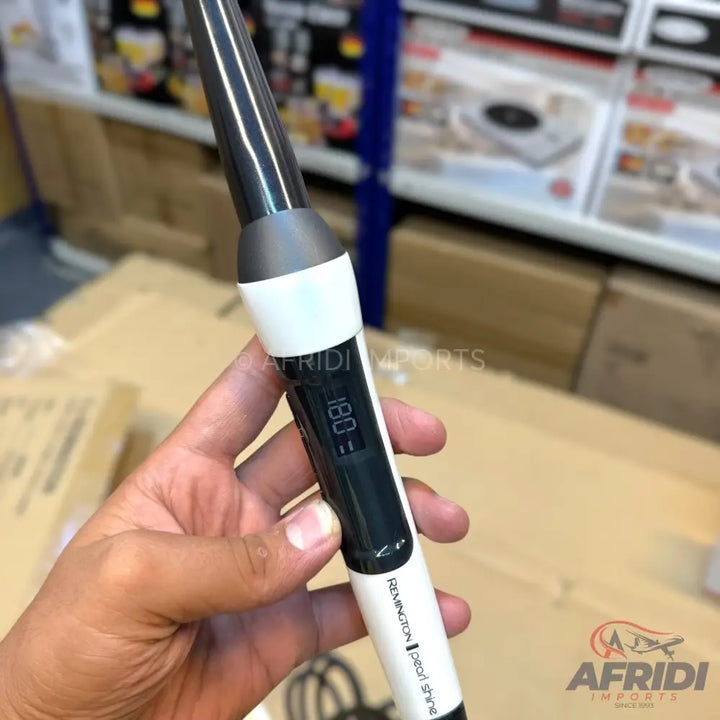 A black and white hair curling wand with a digital temperature display showing 180 degrees Celsius.