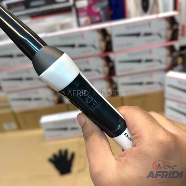 A black and white hair curling iron with a digital temperature display.