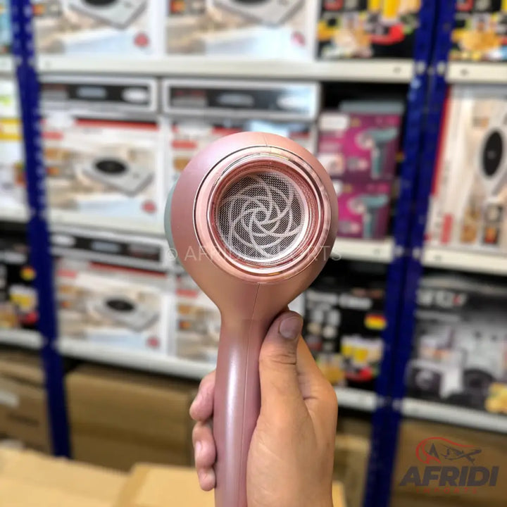 Rose gold handheld hair dryer with a mesh filter.