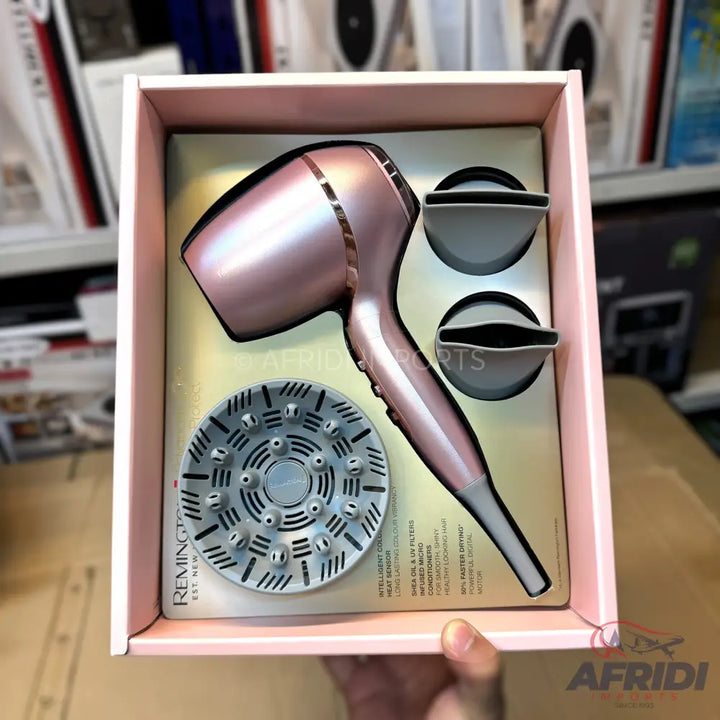 A rose gold hair dryer with a diffuser and two concentrator nozzles.