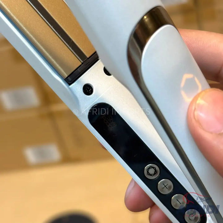 White and black hair straightener with digital controls.