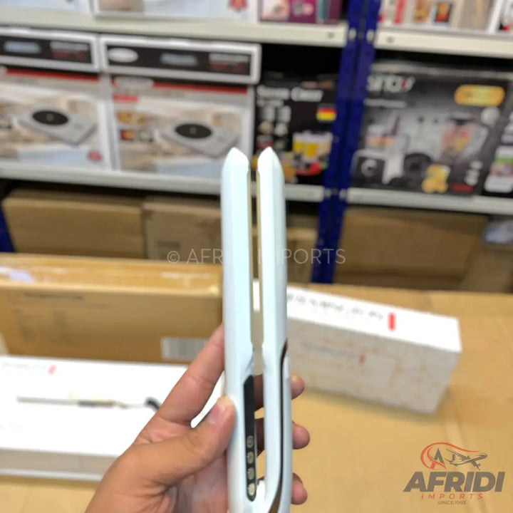 A white and gold cordless hair straightener with digital temperature control.