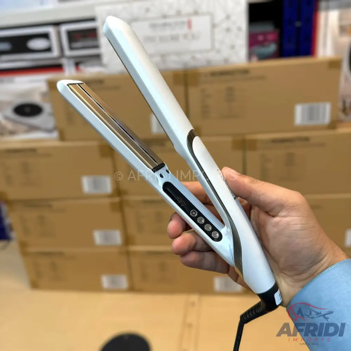 A white and silver hair straightener with a digital display and temperature control buttons.