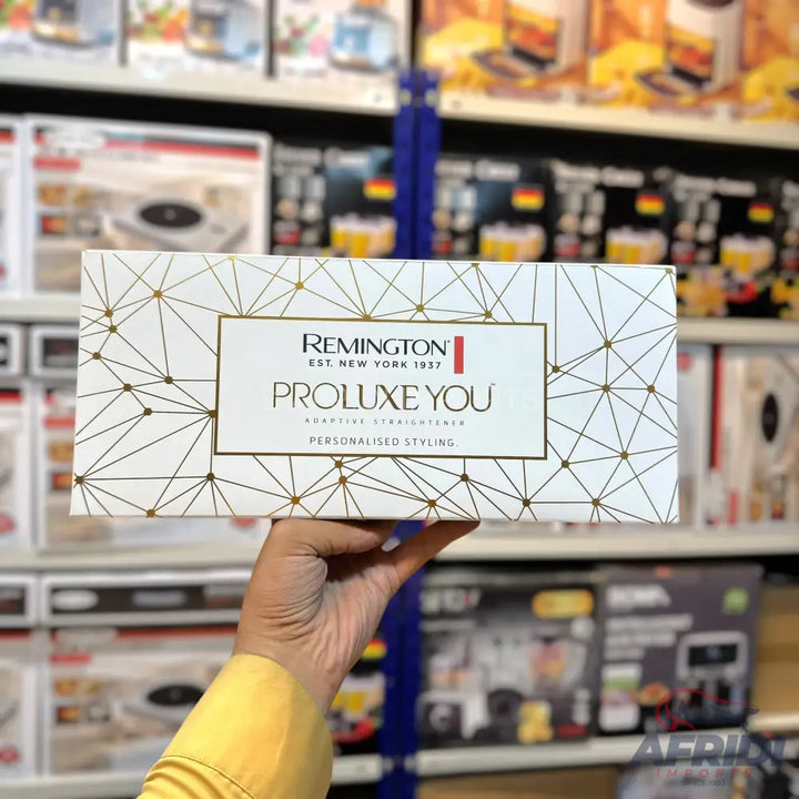 A white box for hair straighteners with gold geometric patterns.
