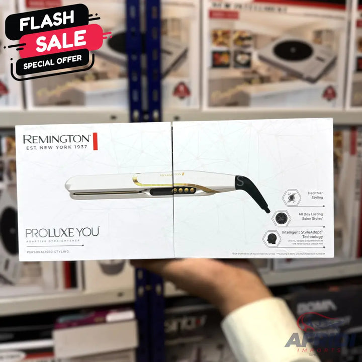 White and gold hair straightener in retail packaging.