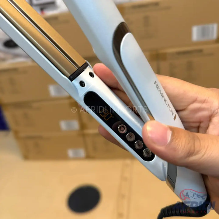White and gold hair straightener with digital temperature display and multiple heat settings.