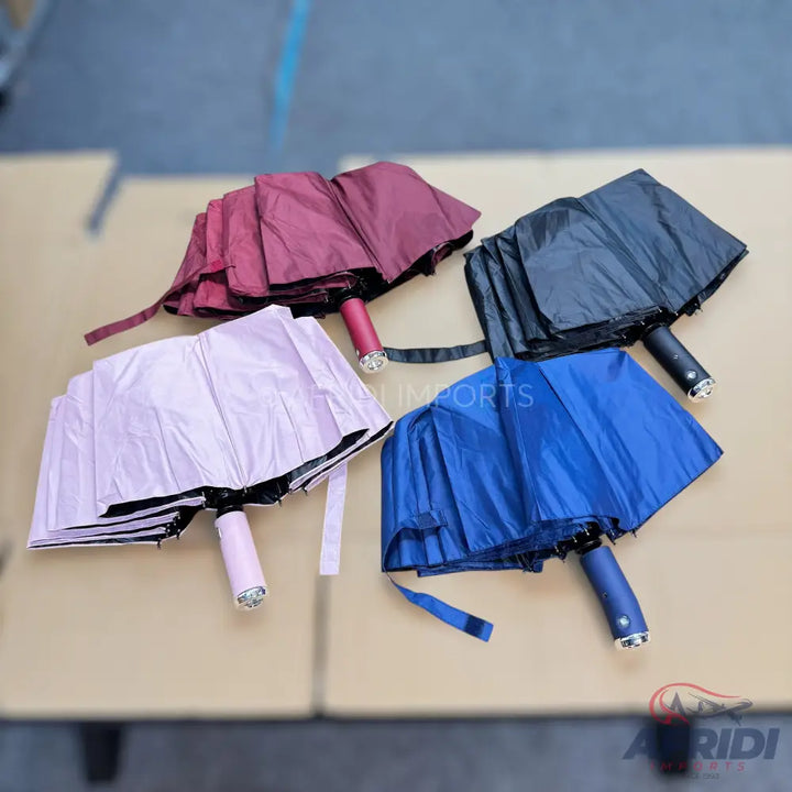 Four compact, foldable umbrellas in various colors.