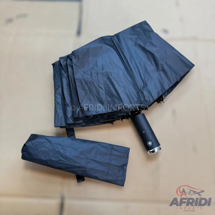 Black compact umbrella with a matching storage sleeve.