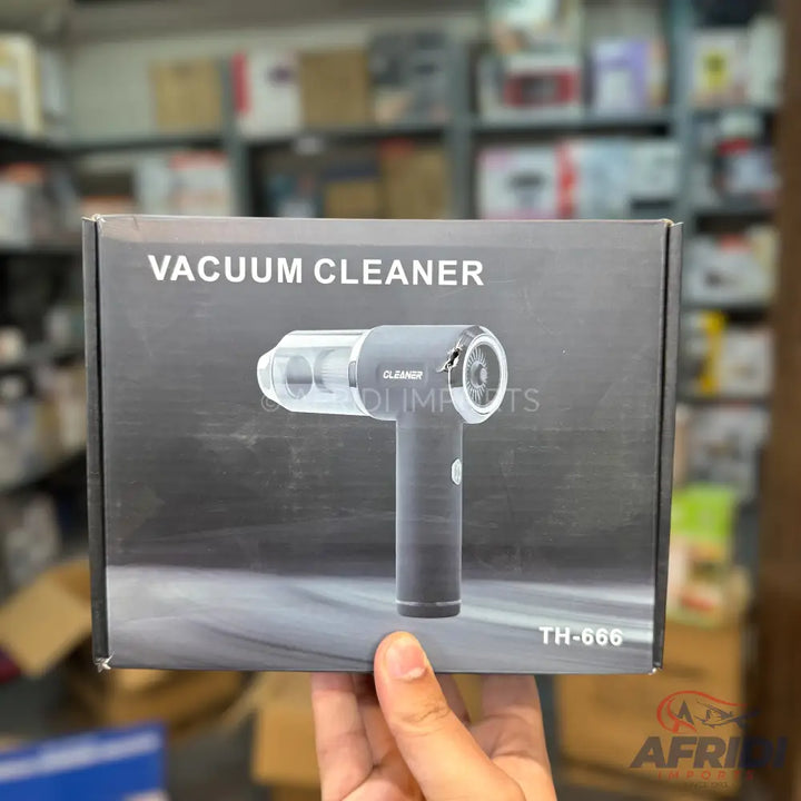 A compact, handheld vacuum cleaner in its product packaging.