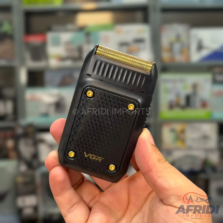 Black and gold electric shaver with a textured grip.