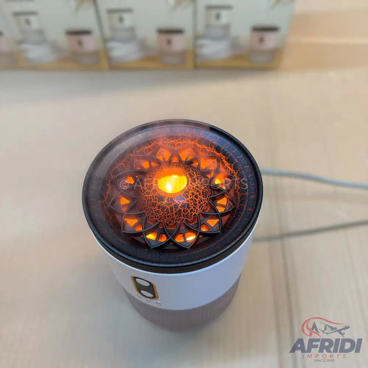 Aromatic diffuser with a decorative, illuminated, mandala-patterned top.