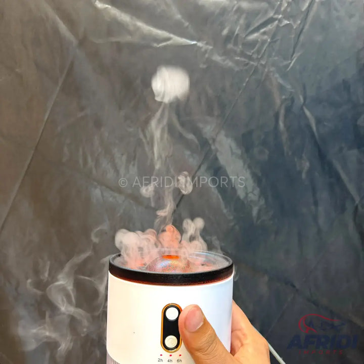 White portable humidifier with visible mist.