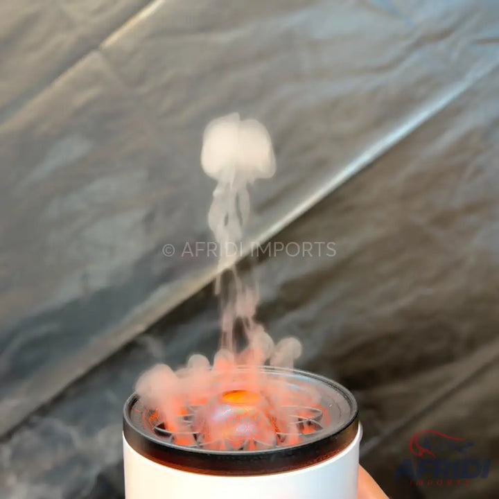 White electric incense burner with glowing embers and smoke forming a jellyfish shape.