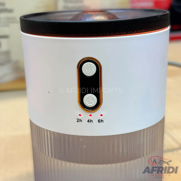 White and clear cylindrical humidifier or diffuser with two gold-rimmed buttons and three timer settings.