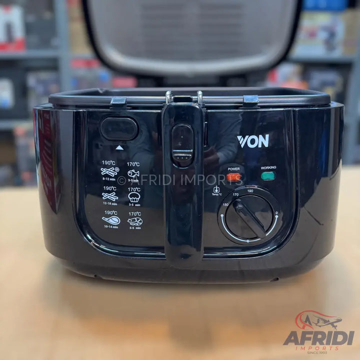 Black electric deep fryer with a temperature control dial and cooking guides.