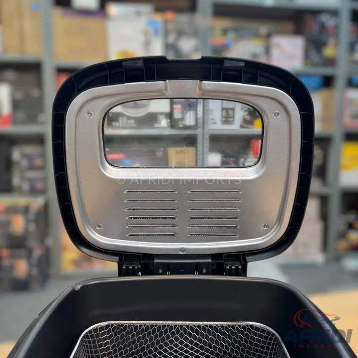Black air fryer with an open lid and a mesh basket.