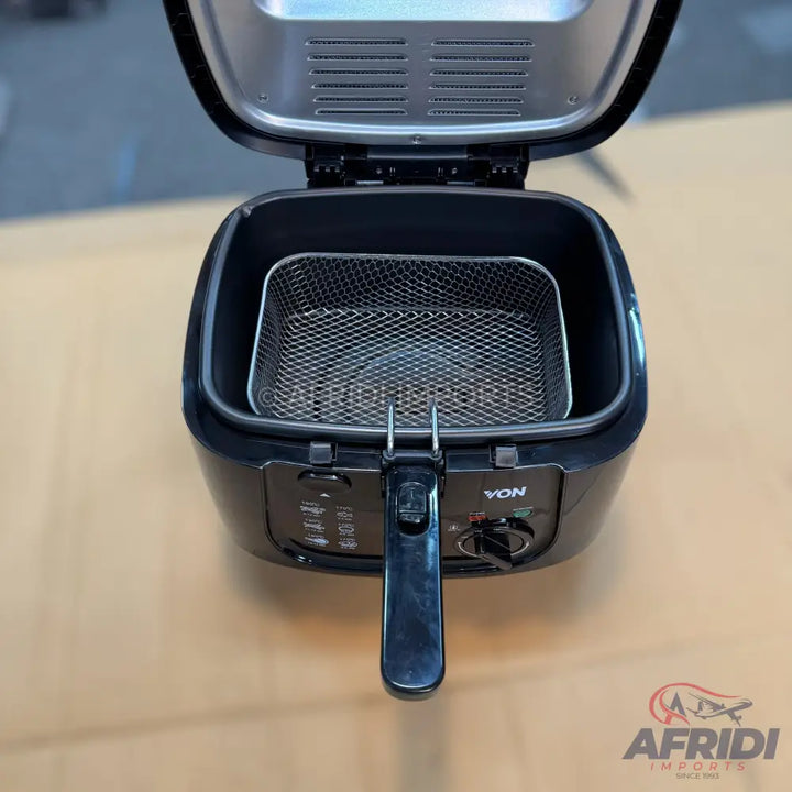 Black deep fryer with an open lid, a removable wire basket, and a temperature control knob.