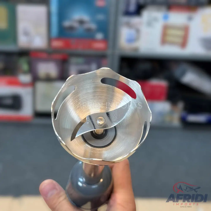 A handheld immersion blender with a stainless steel blending shaft and sharp blades.