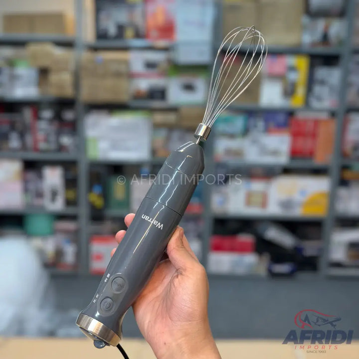 Handheld electric whisk with a gray body and three control buttons.