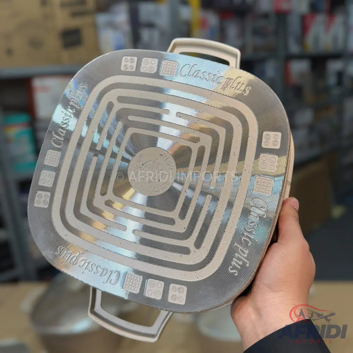 The bottom of a cooking pot with an induction-compatible base.