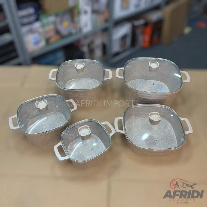A set of five square cooking pots with glass lids.