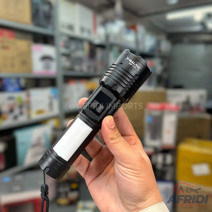 Black tactical flashlight with a side panel light and a digital display.