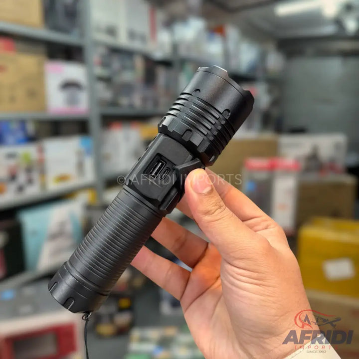 Black tactical flashlight with integrated USB charging and power bank functionality.