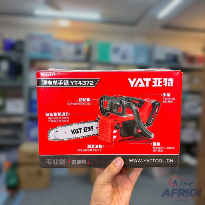 Red and black cordless electric chainsaw in its packaging.