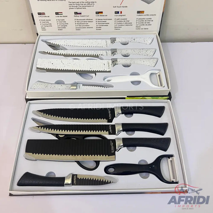 Two sets of kitchen knives and peelers, one with black handles and the other with white and gray speckled handles.