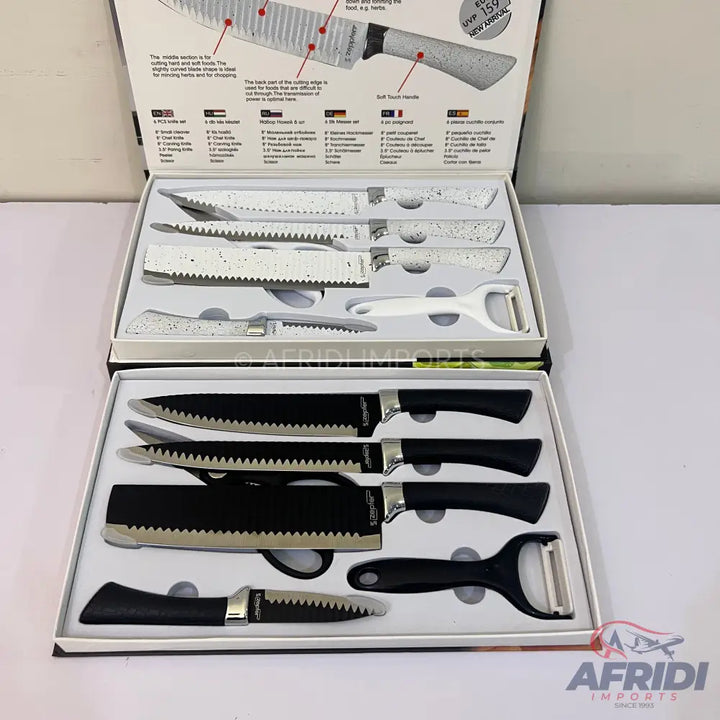 Two boxed sets of kitchen knives and peelers, one with black handles and blades, the other with white speckled handles and blades.